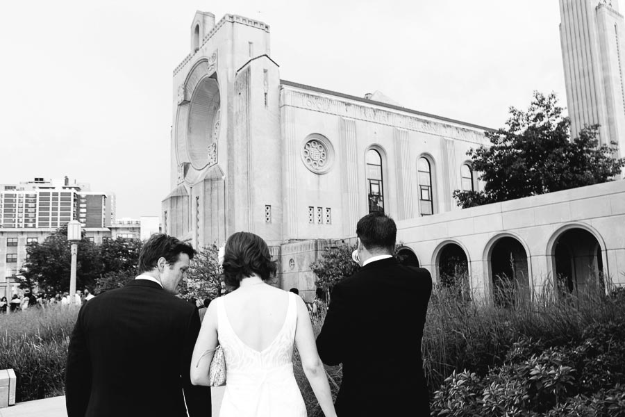 Bride walks towards Madonna Della Strada Chapel on the campus of Loyola University Chicago. Chicago Wedding Photographer