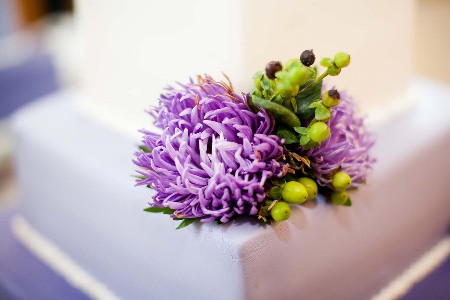 Wedding cake detail with purple flowers Chicago, Illinois Wilder Mansion wedding venue