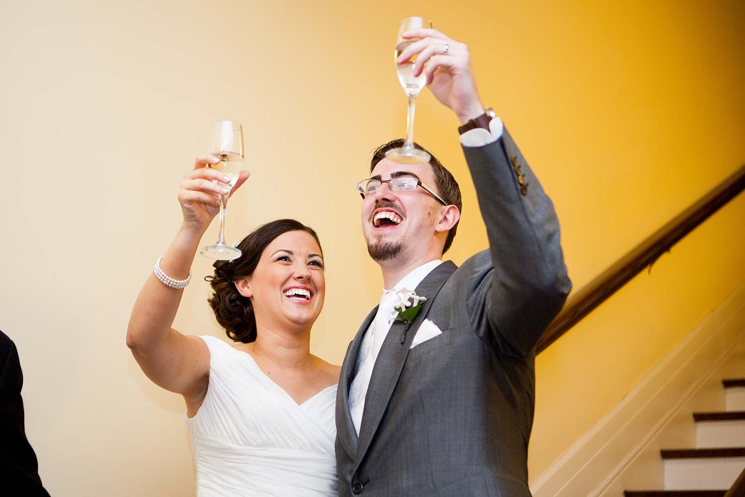 Bride and groom toasting with champagne glasses during wedding reception toasts, Elmhurst, Illinois