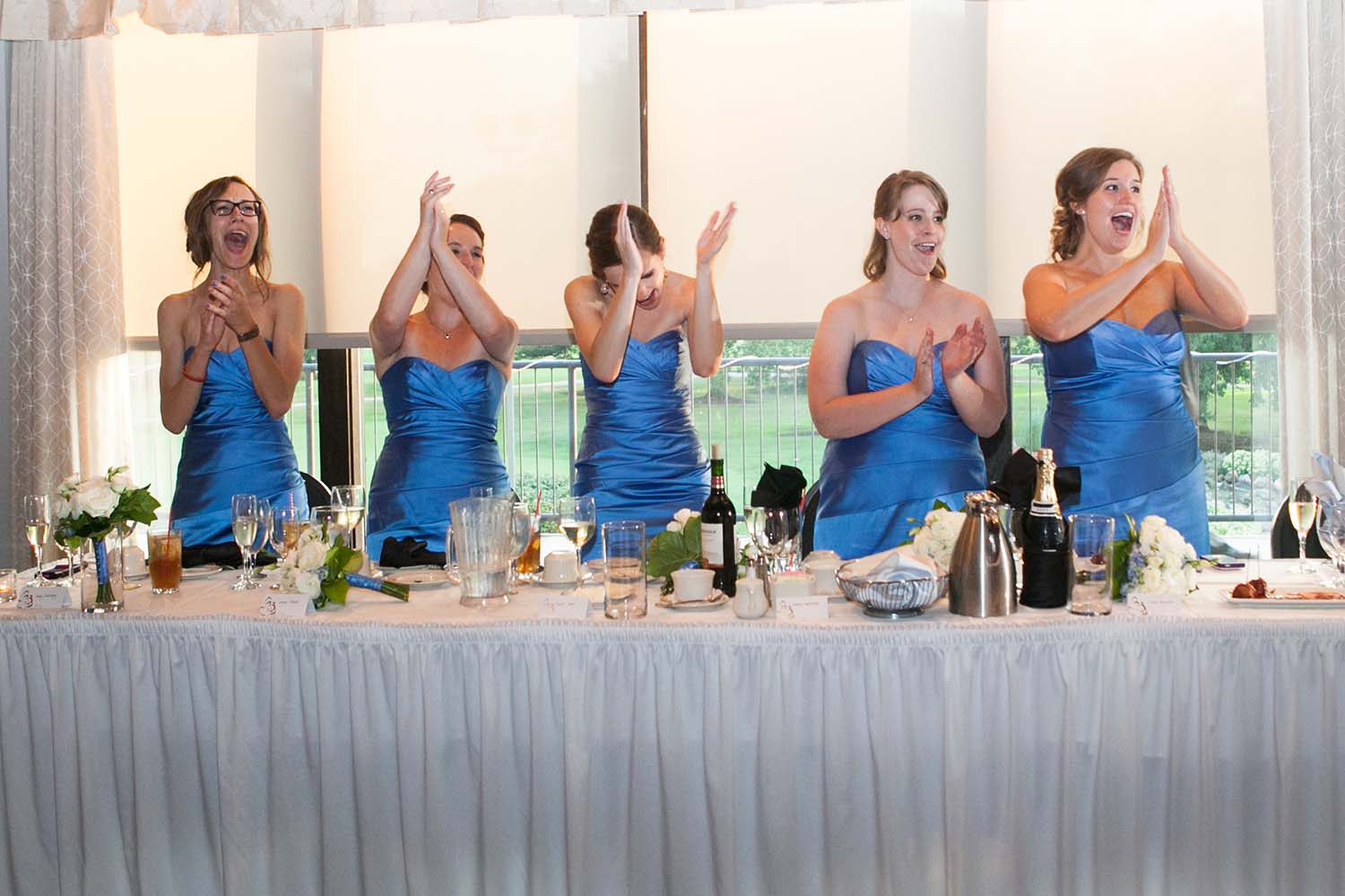 Bridesmaids applaud at reception party. MInneapolis Wedding Photographers