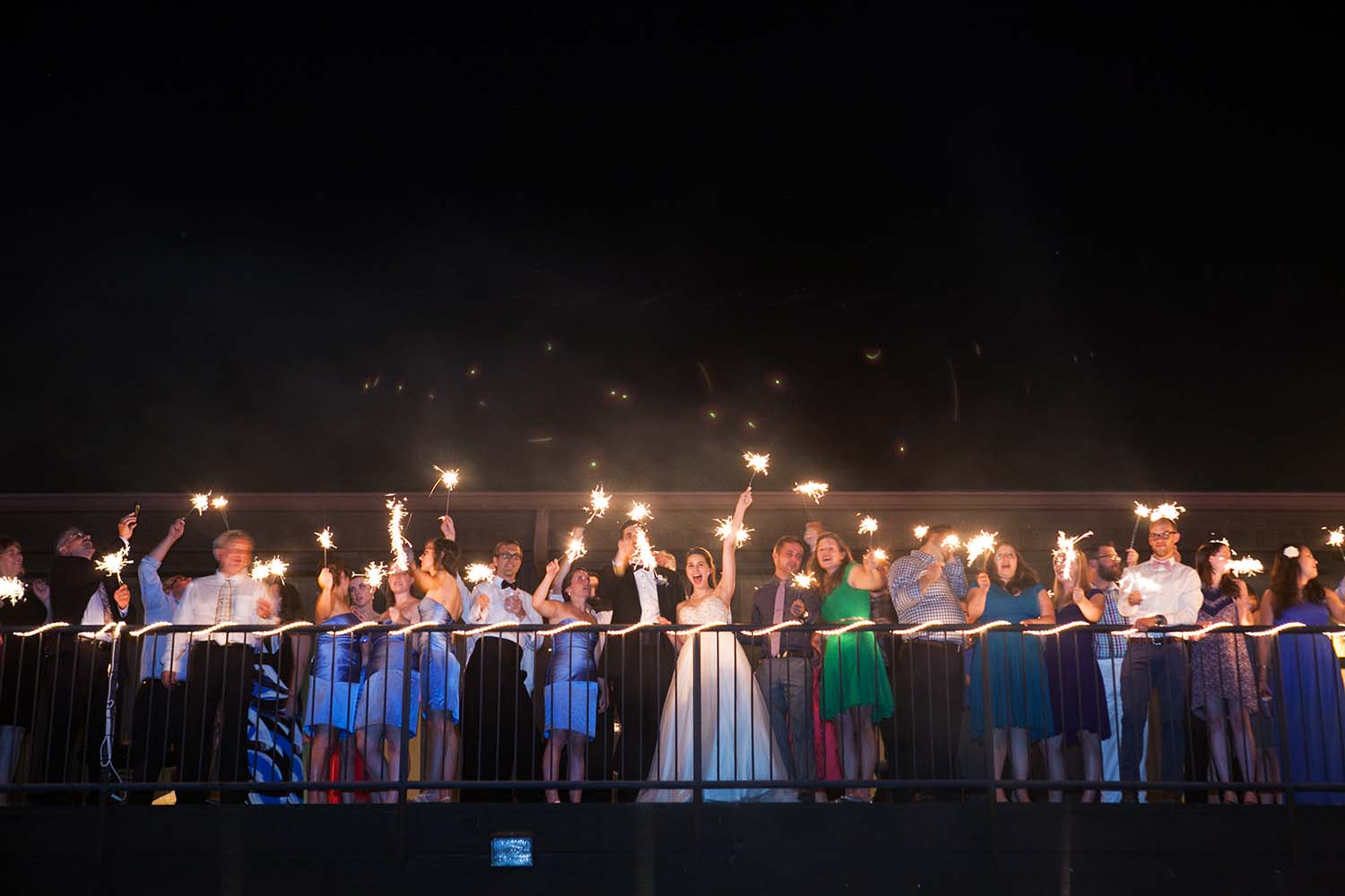 Night portrait  with low light of bridal party in balcony. Minneapolis Wedding Photographers
